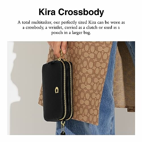 Person holding a black crossbody handbag against a patterned coat.