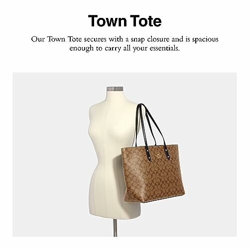 Brown leather tote bag on mannequin with black handles.
