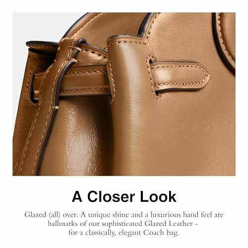 Close-up of a Coach bag in glazed leather with a luxurious hand feel.