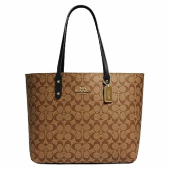 Brown Coach tote bag with signature pattern and black handles.