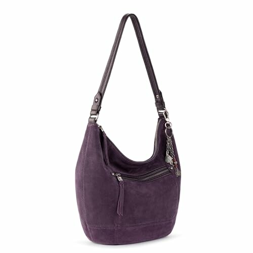 Purple suede shoulder bag with zipper and charm.